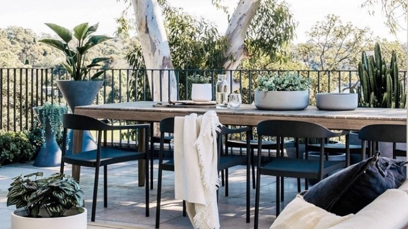 Outdoor balcony with kitchen table and chairs